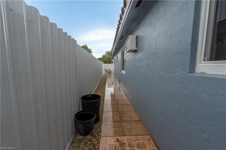 View of home's exterior with a fenced backyard and stucco siding