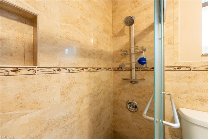 Bathroom featuring a stall shower and toilet
