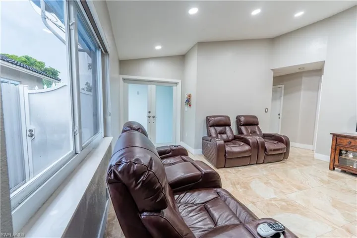 Cinema featuring french doors and recessed lighting