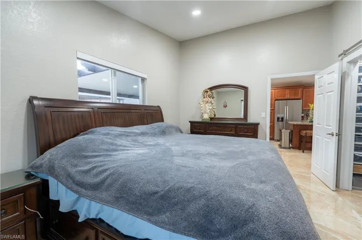 Bedroom with stainless steel fridge