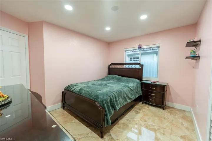 Bedroom with recessed lighting and baseboards