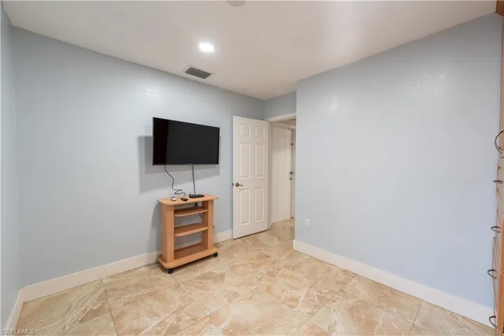 Unfurnished bedroom with baseboards and recessed lighting