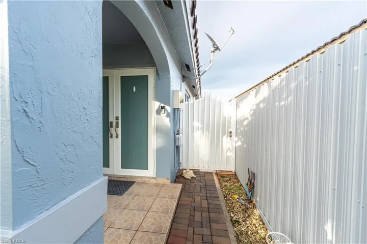 Property entrance featuring stucco siding