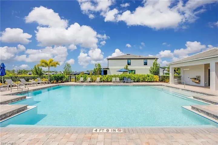 Community pool with fence and a patio
