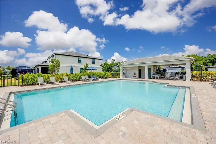 Community pool featuring fence and a patio area