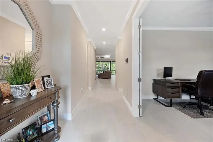 Office area featuring crown molding, baseboards, and light tile patterned flooring