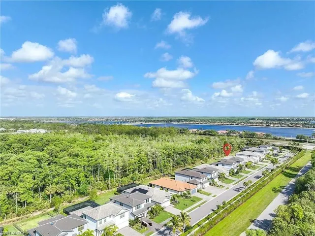 Aerial perspective of suburban area featuring a large body of water