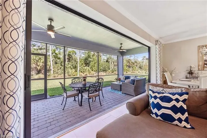 Sunroom featuring ceiling fan, an outdoor hangout area, and healthy amount of natural light