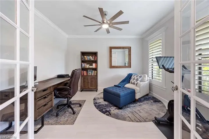 Home office featuring french doors, crown molding, and a ceiling fan