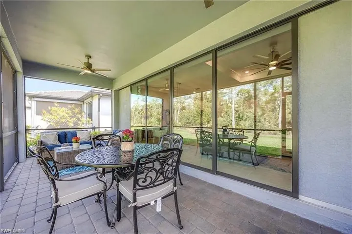 Sunroom featuring ceiling fan and outdoor dining space