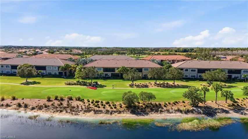 Drone / aerial view of a nearby body of water and a local golf course