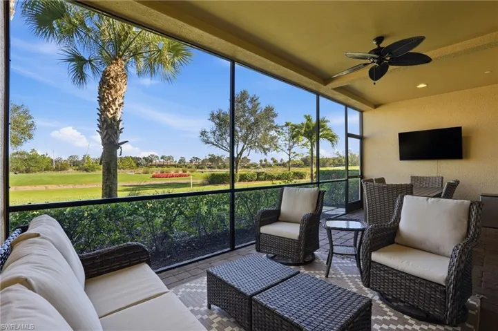 Sunroom featuring an outdoor hangout area, a ceiling fan, and view of golf course