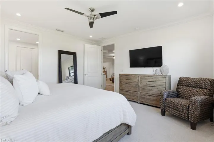 Bedroom featuring carpet floors, a ceiling fan, ornamental molding, and recessed lighting