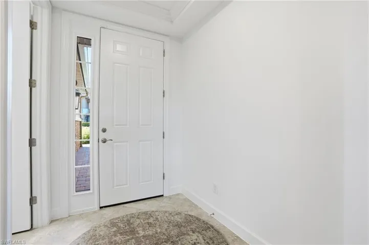 Entryway with plenty of natural light and ornamental molding