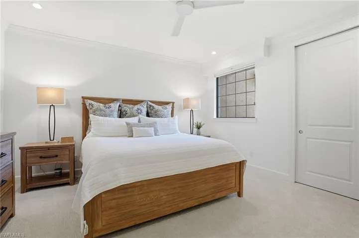Bedroom featuring a ceiling fan, light carpet, ornamental molding, and recessed lighting
