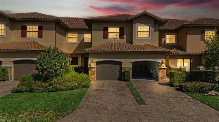 Mediterranean / spanish-style house featuring decorative driveway, stucco siding, stone siding, and a tile roof