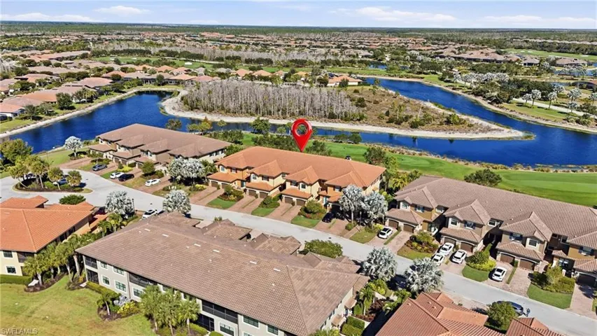 Aerial view of residential area featuring a nearby body of water