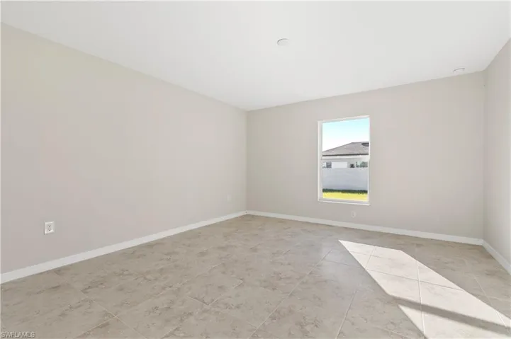 Unfurnished room featuring baseboards and light tile patterned flooring