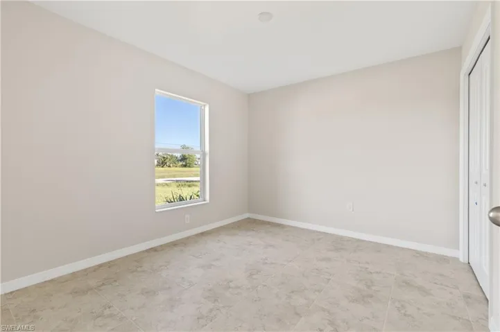 Unfurnished bedroom featuring a closet and light tile patterned flooring