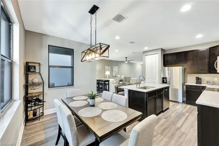 Dining room featuring plenty of natural light, light wood-type flooring, and sink