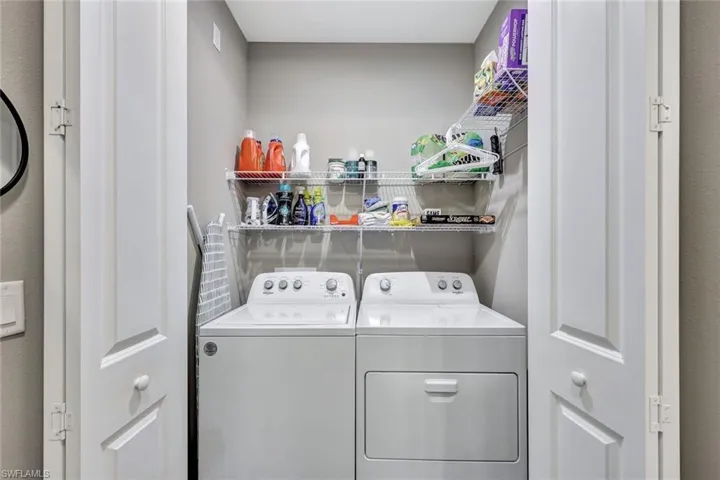 Washroom featuring washing machine and clothes dryer