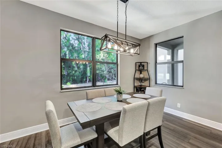 Dining space with dark wood-type flooring and a textured ceiling