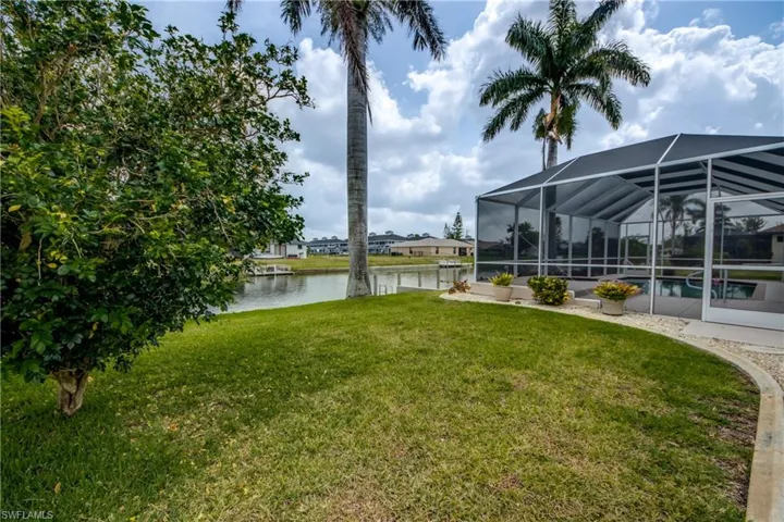 Beautiful Royal Palm Trees in Backyard give Elegance and Shade.  Beautiful well kept yard.