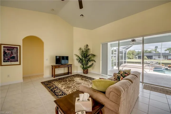 Large 3 Panel Sliders give Light and Huge Views to the Pool/Jacuzzi and Fresh Water Canal.  Beautiful Archway leads to 2 guest bedrooms.