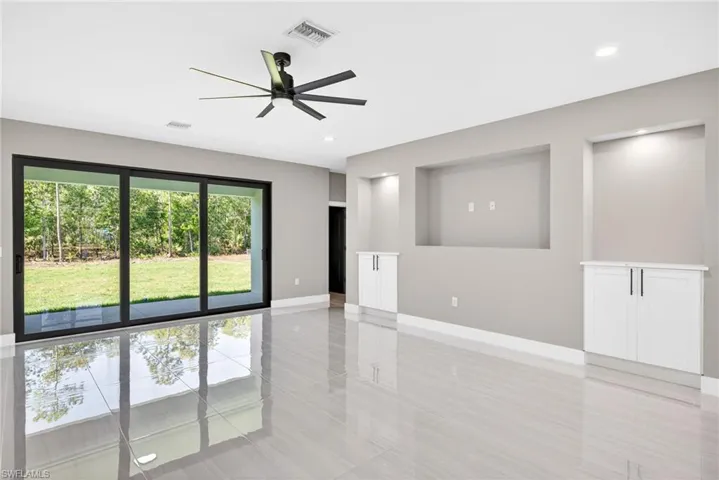 Empty room with a ceiling fan and recessed lighting