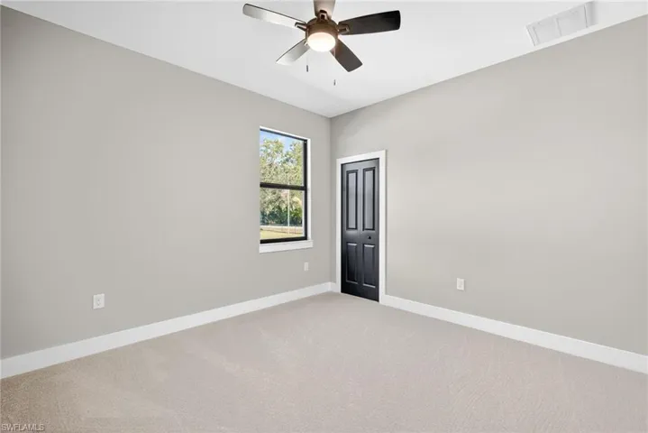 Spare room featuring carpet floors and ceiling fan
