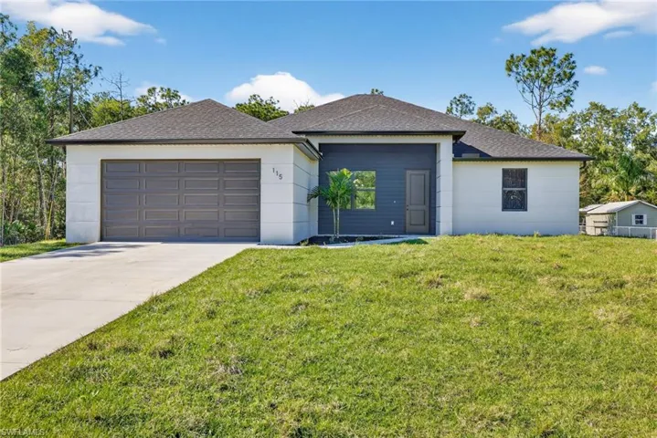 Ranch-style house featuring a front lawn, concrete driveway, roof with shingles, and an attached garage