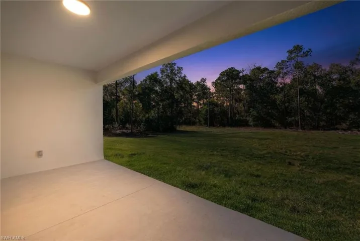 Yard at dusk featuring a patio area and a yard