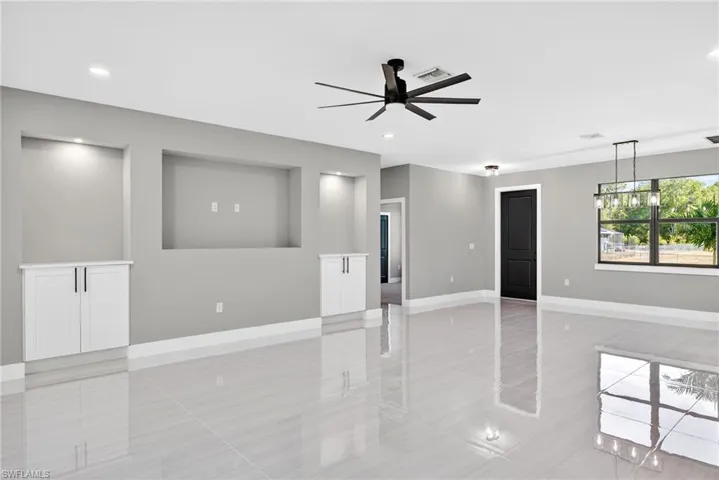 Empty room with a ceiling fan and recessed lighting