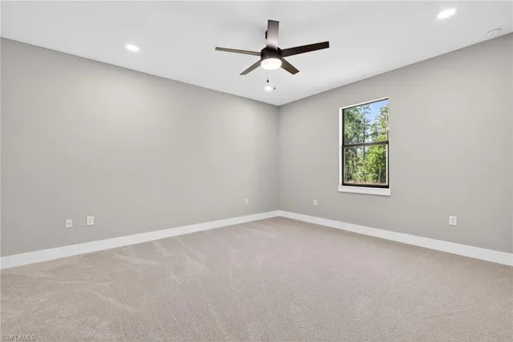 Spare room with light carpet, recessed lighting, and ceiling fan