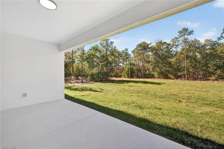 View of grassy yard with a patio