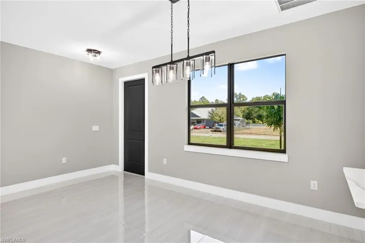 Unfurnished dining area with baseboards and a chandelier