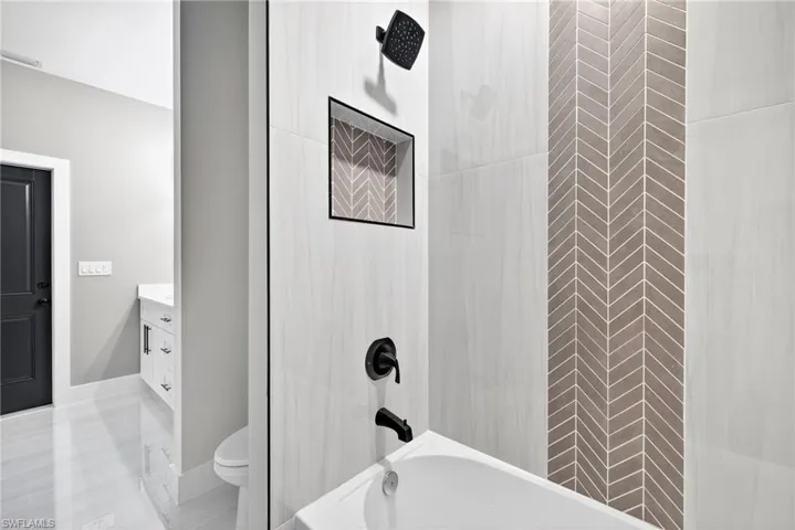 Full bath featuring vanity and shower / tub combo