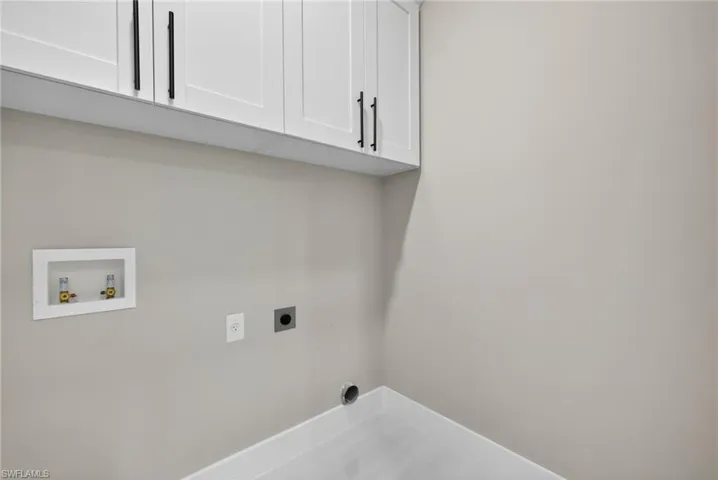 Laundry room with cabinet space, electric dryer hookup, and hookup for a washing machine