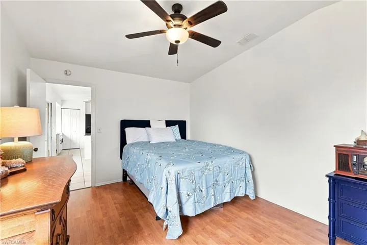Bedroom featuring wood-finish flooring and a ceiling fan with integrated lighting