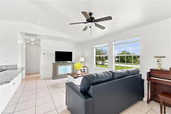 Bright living area featuring tile flooring and a ceiling fan