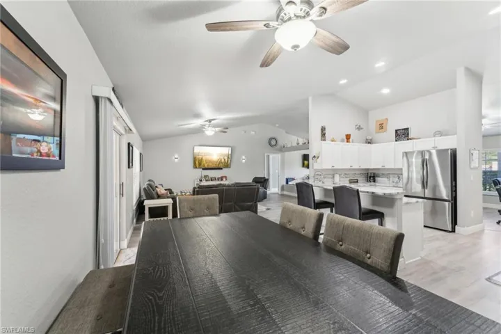 Dining area with a ceiling fan and vaulted ceiling