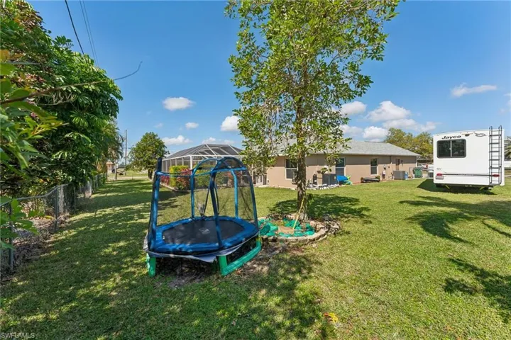 View of yard featuring a trampoline