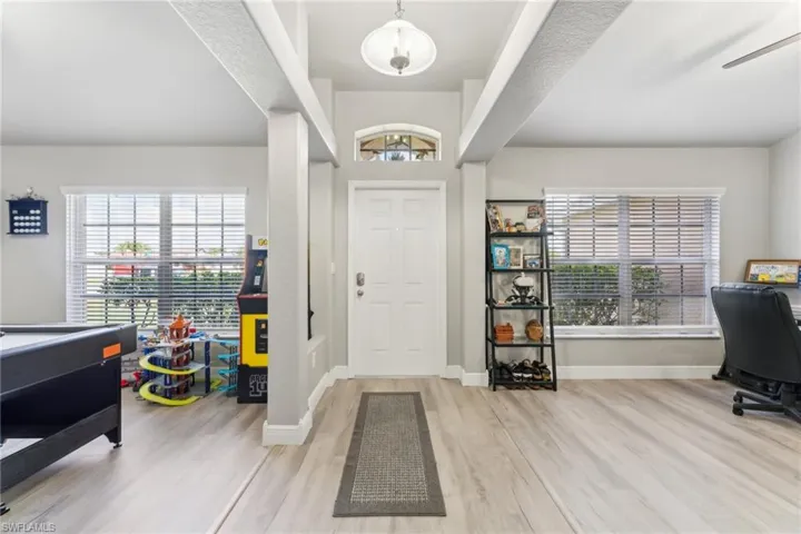 Entrance foyer featuring wood finished floors, baseboards, and a ceiling fan