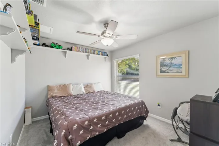 Bedroom featuring carpet flooring, baseboards, and ceiling fan