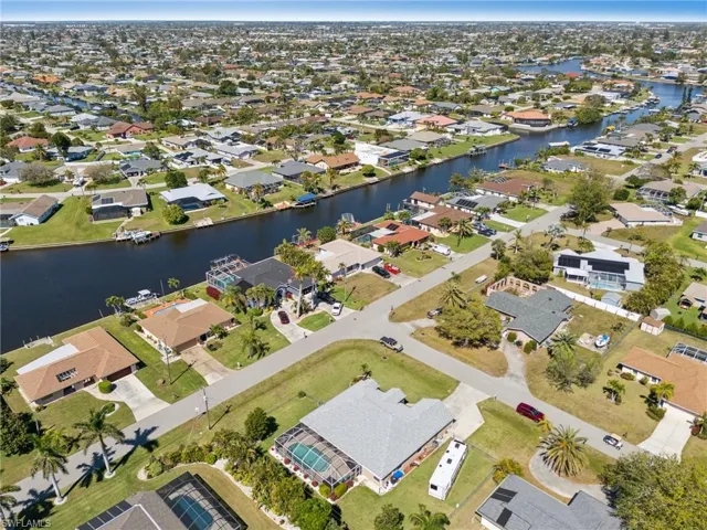 Aerial overview of property's location with nearby suburban area and a nearby body of water