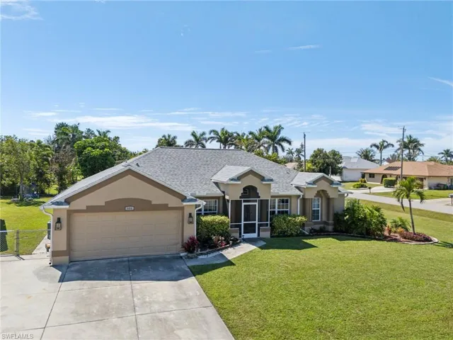 Ranch-style home with driveway, stucco siding, and an attached garage