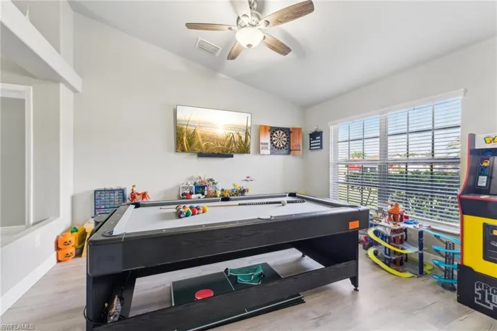 Playroom featuring vaulted ceiling, wood finished floors, and a ceiling fan