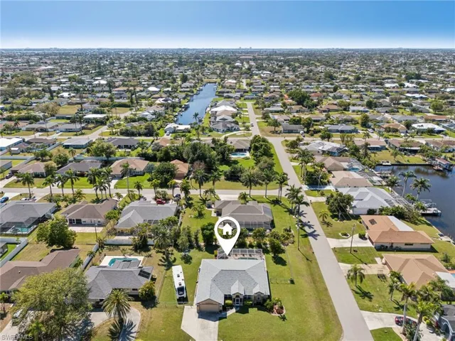 Aerial view of property's location featuring nearby suburban area and a large body of water