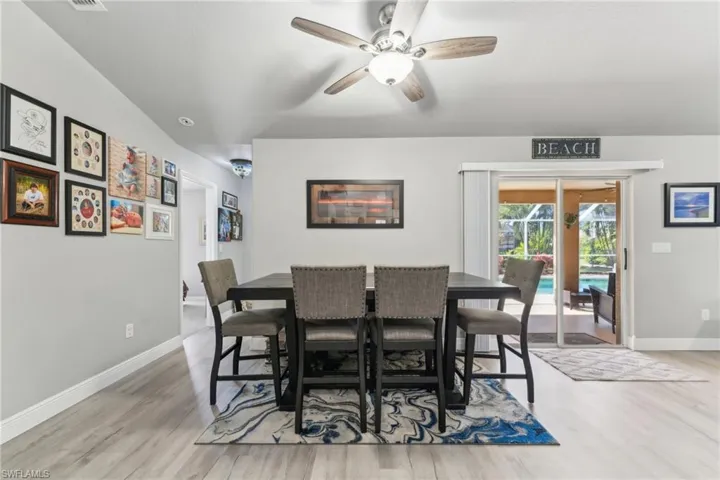 Dining room with wood finished floors, baseboards, and a ceiling fan