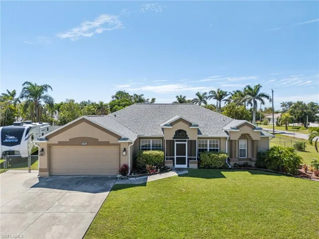 Single story home with a garage, stucco siding, and driveway